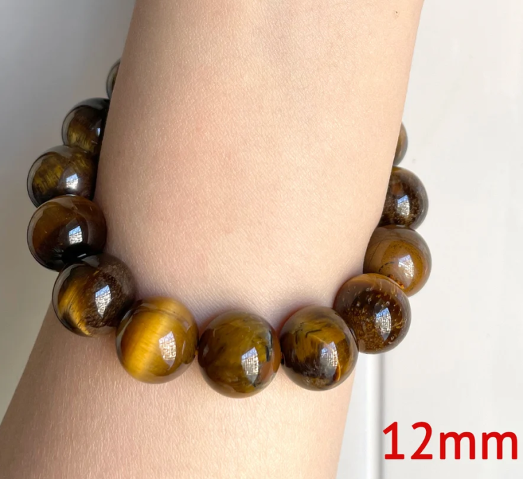 12mm brown Tiger Eye beaded bracelet with handcrafted Bali silver bead on wrist.