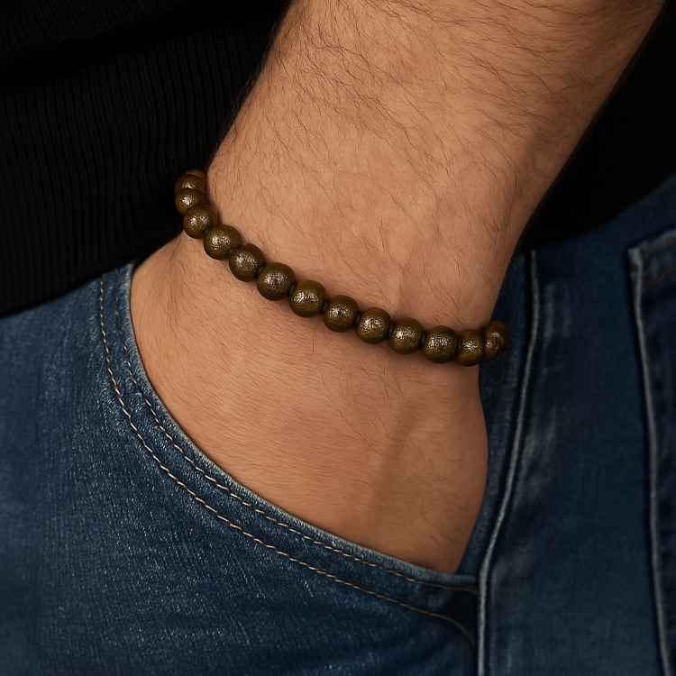 Natural bronzite stone beads bracelet worn on wrist.